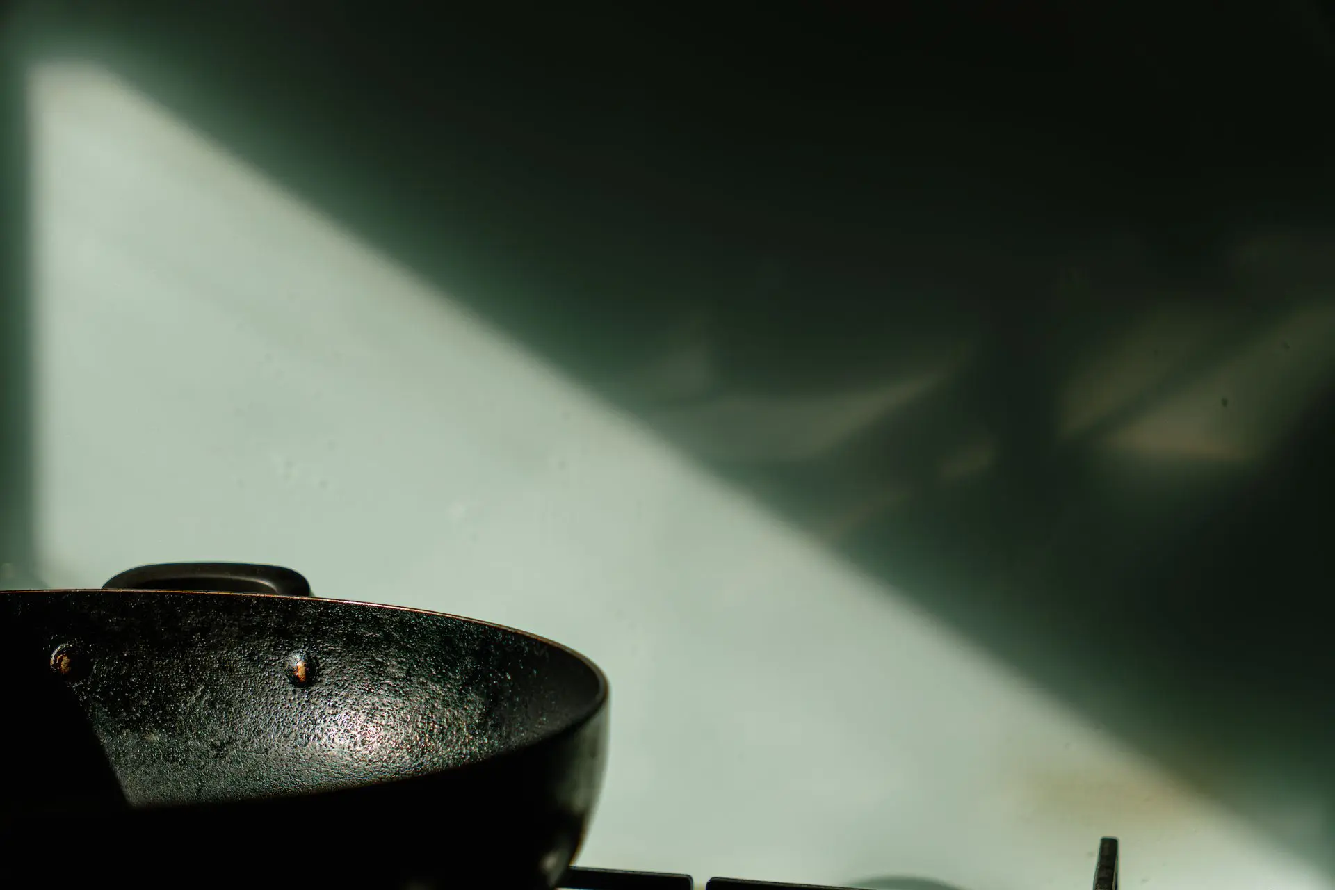 Kitchen 1 A wok against a green background and lit by the sun